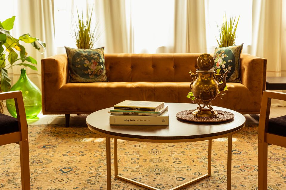 Studio Props - Brown Couch, Black Marble Coffee Table, Books, Antique Gold Lamp, and Plants.